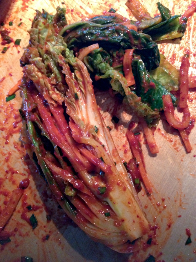 The kimchi paste mixture gets spread liberally between every leaf of the cabbage segments. 